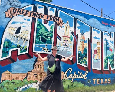 woman in front of Austin mural