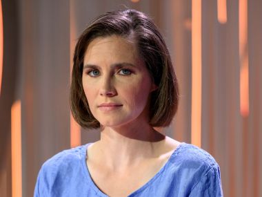 amanda knox looks upset-ish in a blue top