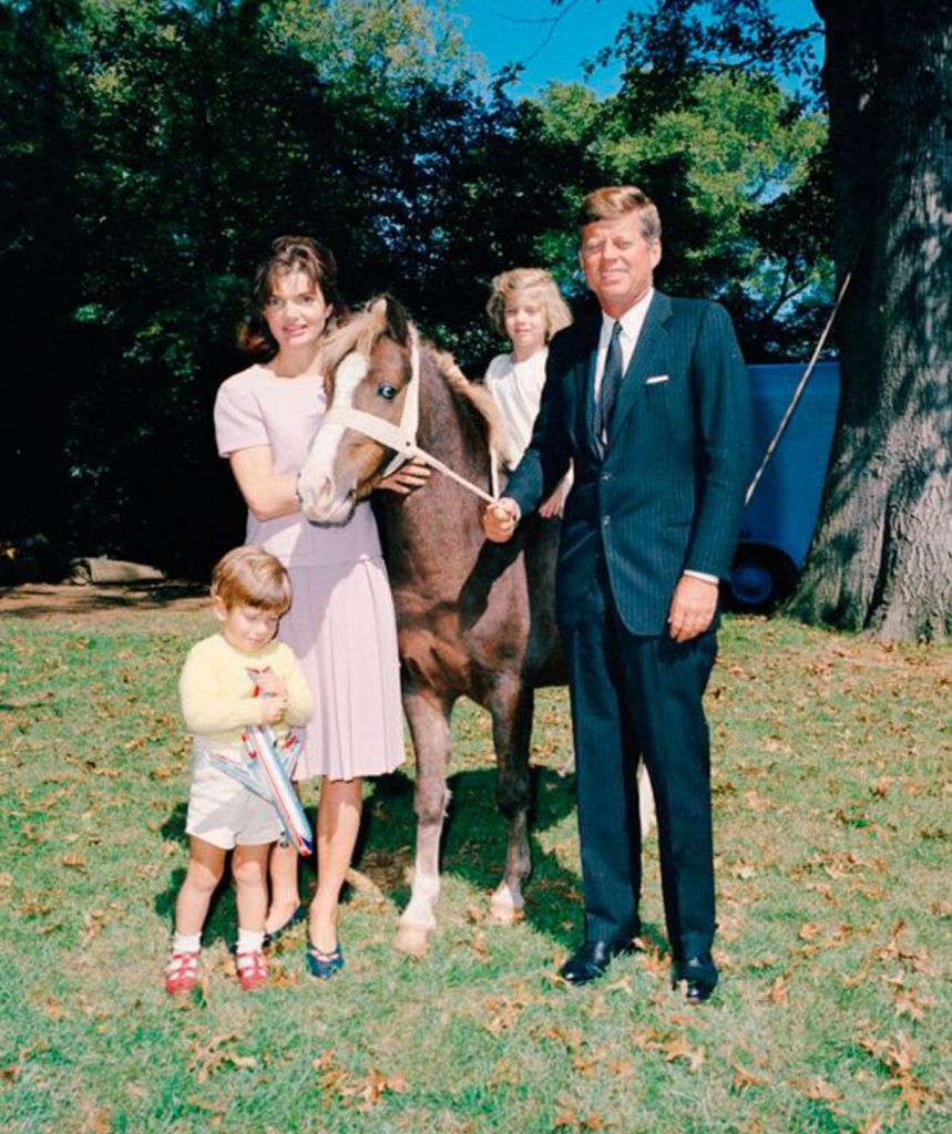 The Kennedys pose with a horse and two children outdoors