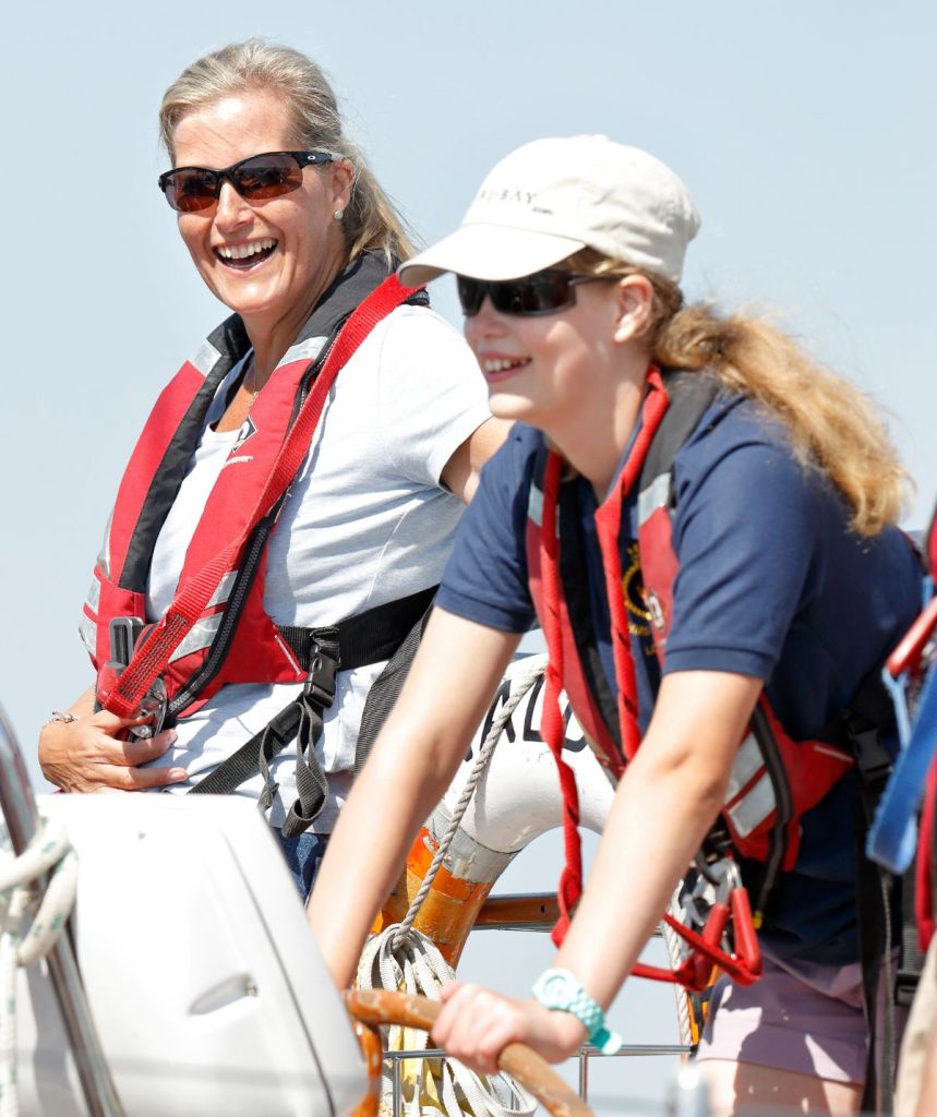 Sophie and Louise wear lifejackets aboard a yacht