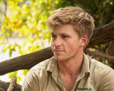 Robert Irwin wears khaki looks to the left