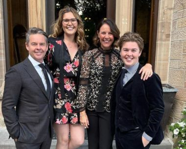 Todd Woodbridge poses with family dressed nicely outdoors