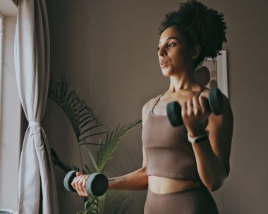 woman doing dumbbell bicep workout at home