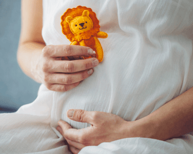 baby’s star sign: Small baby sleeping while holding a cardboard cutout of a moon